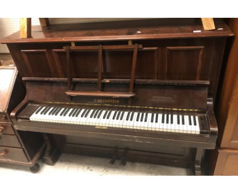 An early 20th Century rosewood cased upright piano, the iron frame over strung movement by C Bechstein 150 cm wide x 59 cm de