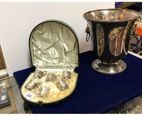 A set of six Victorian tot cups with glass liners and embossed silver holders in the Dutch taste (by James Dixon &amp; Sons o