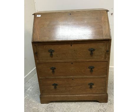 An early 20th Century oak bureau, the sloping fall above three long drawers, 80 cm wide x 46.5 cm deep x 103 cm high, togethe