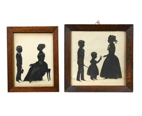 Two early Victorian family group silhouette portraits, the larger showing three children, the eldest being presented with a s