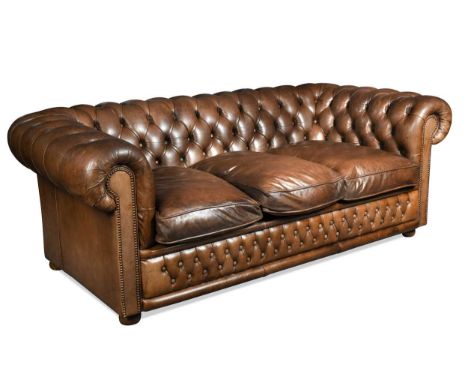 A Chesterfield three-seater sofa by Flemming and Howland, modern, upholstered in a brown button-back leather, with three loos