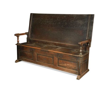 An oak monk’s bench, late 17th century, the two plank top above a boxed seat with two hinged compartments on sledge feet80 x 