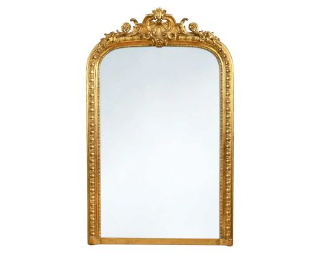 A Victorian gilt overmantel mirror, of arched form, with egg-and-dart moulded frame surmounted by a shell165 x 106cm