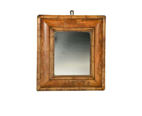 A walnut cushion mirror, 18th century, the later rectangular plate within a cushion-moulded frame49 x 45cmsome fading, drynes