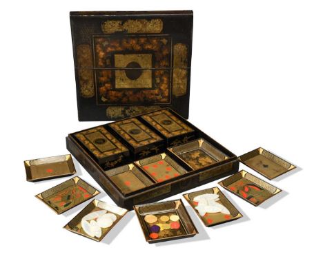 A mid-19th century Chinese export black lacquer games box, gilt floral panels and grapevine bands enclosing the central oval 