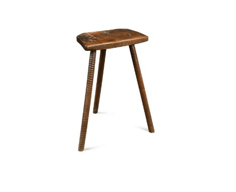 A provincial elm seated stool, 19th century, the shaped seat raised on three ring turned legs, stamped to the underside 'J.B.