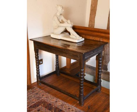 An oak side table, 17th century,  with end drawer, on bobbin legs united by a stretcher74 x 95 x 55.5cm ProvenanceBaldwin Man