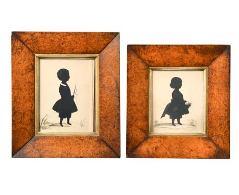 Two early Victorian silhouette portraits of a young boy and girl, the girl holding a flower basket, the boy holding a small r