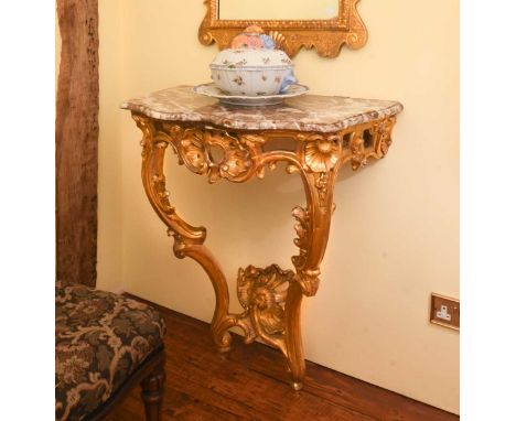 A Rococo style carved giltwood console table, 19th century,  with marble top90 x 83 x 47cmProvenanceBaldwin Manor, Swaffham P