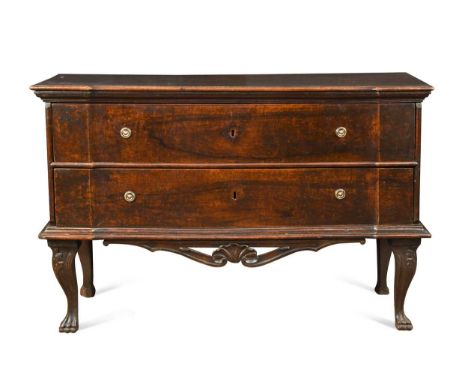 An Italian walnut inverted breakfront commode, 18th century, with two long drawers above a shell-carved apron raised on cabri