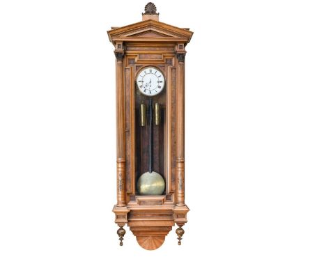 An impressive Vienna figured walnut chiming wall clock, the arched top above two piece white dial with three train gong strik