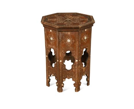 An Islamic hardwood occasional table, probably late 19th century Syrian, in the manner of those retailed by Liberty, each of 