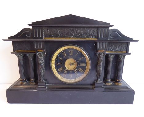 A large late 19th century black slate mantel clock in Classical style and with gilded French movement; the black and gold cha