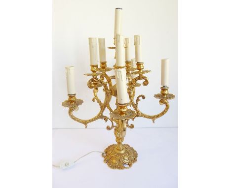 A gilt-metal eleven-light table candelabra fitted for electricity