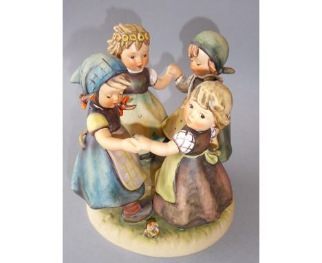 A large Hummel porcelain figure group, 'Ring around the Rosie' (18cm high, 16.25cm diameter of circular base)Appears to be in