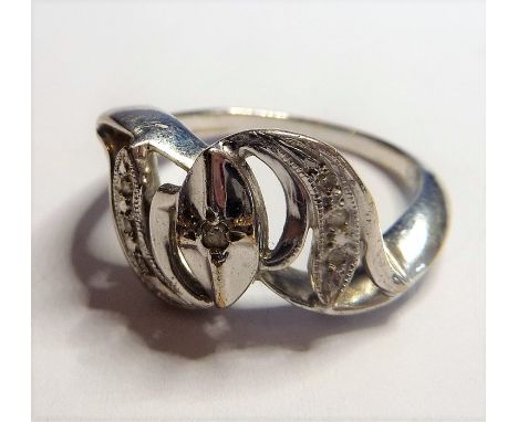 A white-metal ring marked 14K; central oval design flagged by two crescent shoulders set with small white stones, ring size L