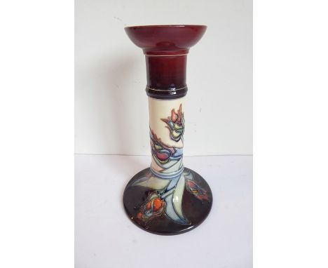 A Moorcroft Pottery table candlestick; tube-lined and decorated with stylised tulips, impressed and printed marks to undersid