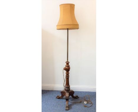 An adjustable walnut lamp standard and shade; 19th century carved fluted column above a tripod base with further carving