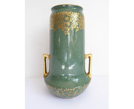 A Royal Worcester vase of cylindrical form with a pair of gilt handles in the Art Deco style; the body in mottled green celad