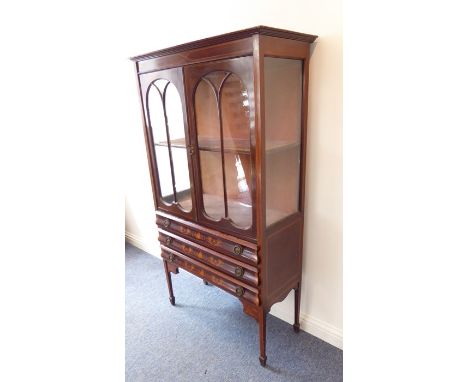 A good and unusual early 20th century mahogany and marquetry display cabinet; the two glazed doors with arches and enclosing 