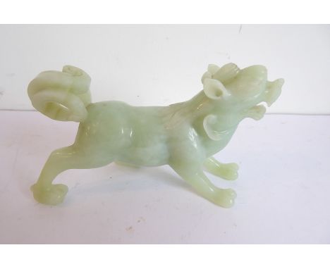 A heavy carved Chinese jade model of an open-mouthed qilin with bifid tail (14cm wide x 8.5cm highest)