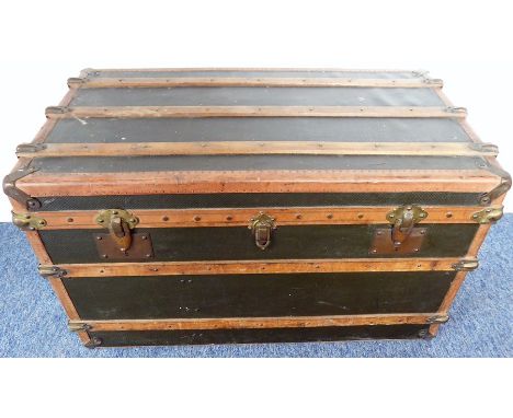 A good-quality&nbsp;early 20th century travelling trunk;&nbsp;leather-bound and metal-mounted, one leather side carrying hand