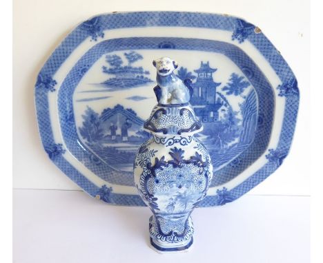 An 18th century Delft blue-and-white vase-and-cover; decorated with a panel depicting a romantic scene, cover with dog finial