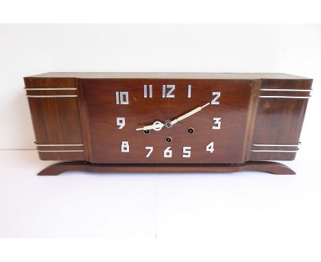 A French Art Deco-style walnut mantel clock with steel Arabic numerals, the movement striking on five gongs (55.5cm diameter)