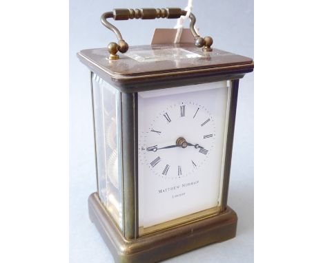 A brass and glass-sided carriage clock by Matthew Norman (London), the gilded movement signed and with keyThe Auctioneer stat