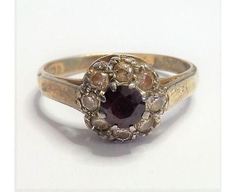 An early 20th century silver ring centrally set with a hand-cut dark-blue stone surrounded by a further white stone cluster-s