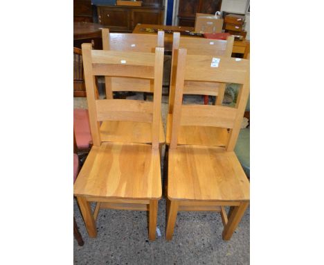 Set of four modern light oak hard seated dining chairs