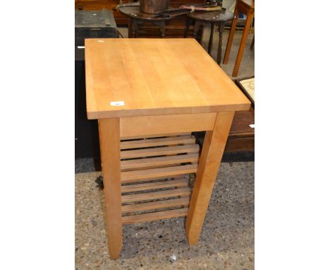 Modern light wood kitchen table with shelves beneath