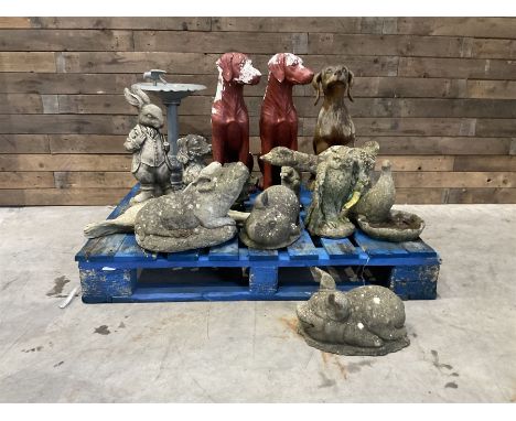 Various cast stone and composite garden ornaments, to include Peter Rabbit, goose, pigs, dogs, dog with wheelbarrow, painted 