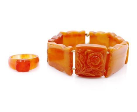 Amber panelled bracelet and carnelian ring the bracelet has carved panels and strung on elastic and is showing signs of damag