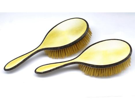 George V silver and enamel dressing brushes with guilloche yellow enamel and black enamel floral borders. Marked Birmingham19