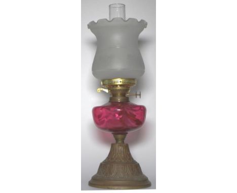 Victorian oil lamp with ruby glass reserve, 54cm tall.
