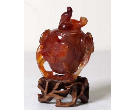 Good Chinese agate carved snuff bottle well carved with flowers, leaves and birds. A bird finial. Fitted wooden stand. (repai