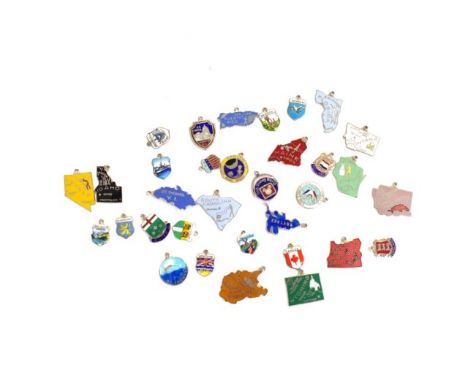 A collection of enamel tourist charms includes base metal and silver pieces, Apollo 15, 14 and a Walt Disney world spinner