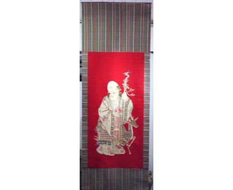 Hanging Chinese silk embroidery scroll depicting a Sage with Deer, on red ground, (300cm X 105cm approx, total; 182cm X 87cm 