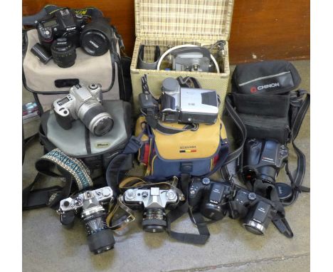 A collection of cameras including a Nikon D80 with three lenses, 50mm, 18-135mm, 55-200mm, SB-600 flash, two Kodak Pixpro AZ4