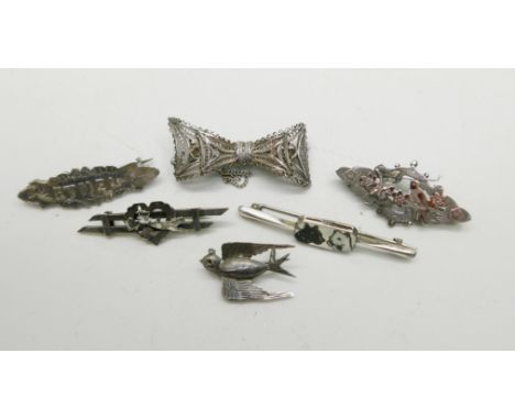 A silver and enamel dog brooch, three Victorian bar brooches, a white metal filigree brooch, and a white metal bird brooch, a