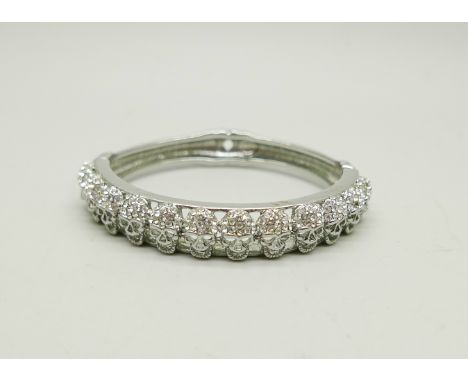 A Butler &amp; Wilson skull bangle, missing stones, 6cm x 5cm 
