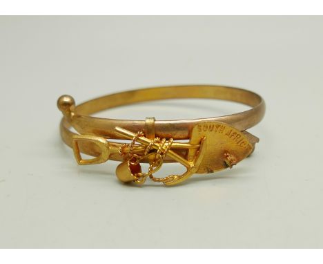 A Victorian unmarked rolled gold South Africa mining bangle, in a fitted case 