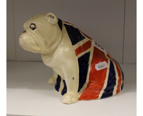 Royal Doulton model of a large seated Bulldog: Draped with union jack flag c1940, height 15cm, (chip to foot and hole to shou