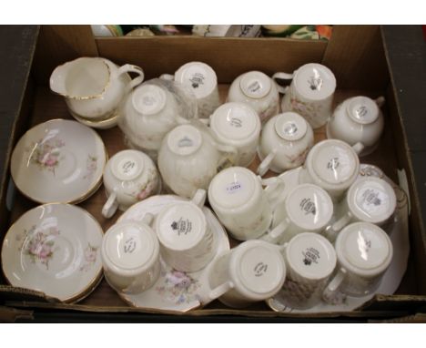A collection of pink floral tea and coffee ware items: mugs, saucers, cups, milk and sugar etc (1 tray). 