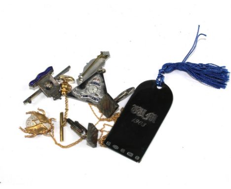 A pair of silver cufflinks, a tie tack, a blue brooch and two military badges and a silver book mark