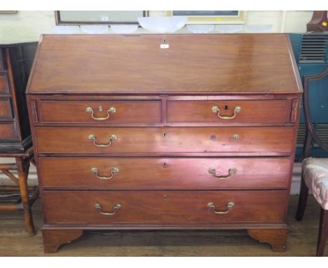 A George III mahogany bureau, the sloping fall enclosing a fitted interior over two short and three long graduated drawers on
