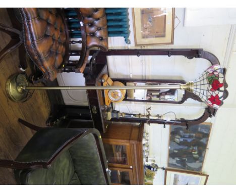 A Tiffany style uplighter shade on a brass standard floor lamp base, 35cm diameter, 181cm high