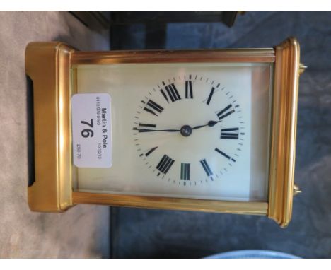 A large brass carriage clock, with cream enamel dial, single train movement 17cm high