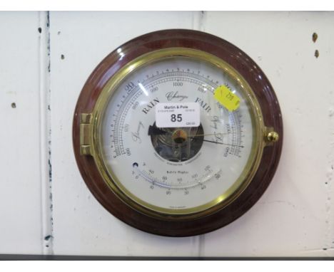 A Kelvin Hughes circular wall barometer with mahogany mount, silver dial and thermometer 21cm diameter